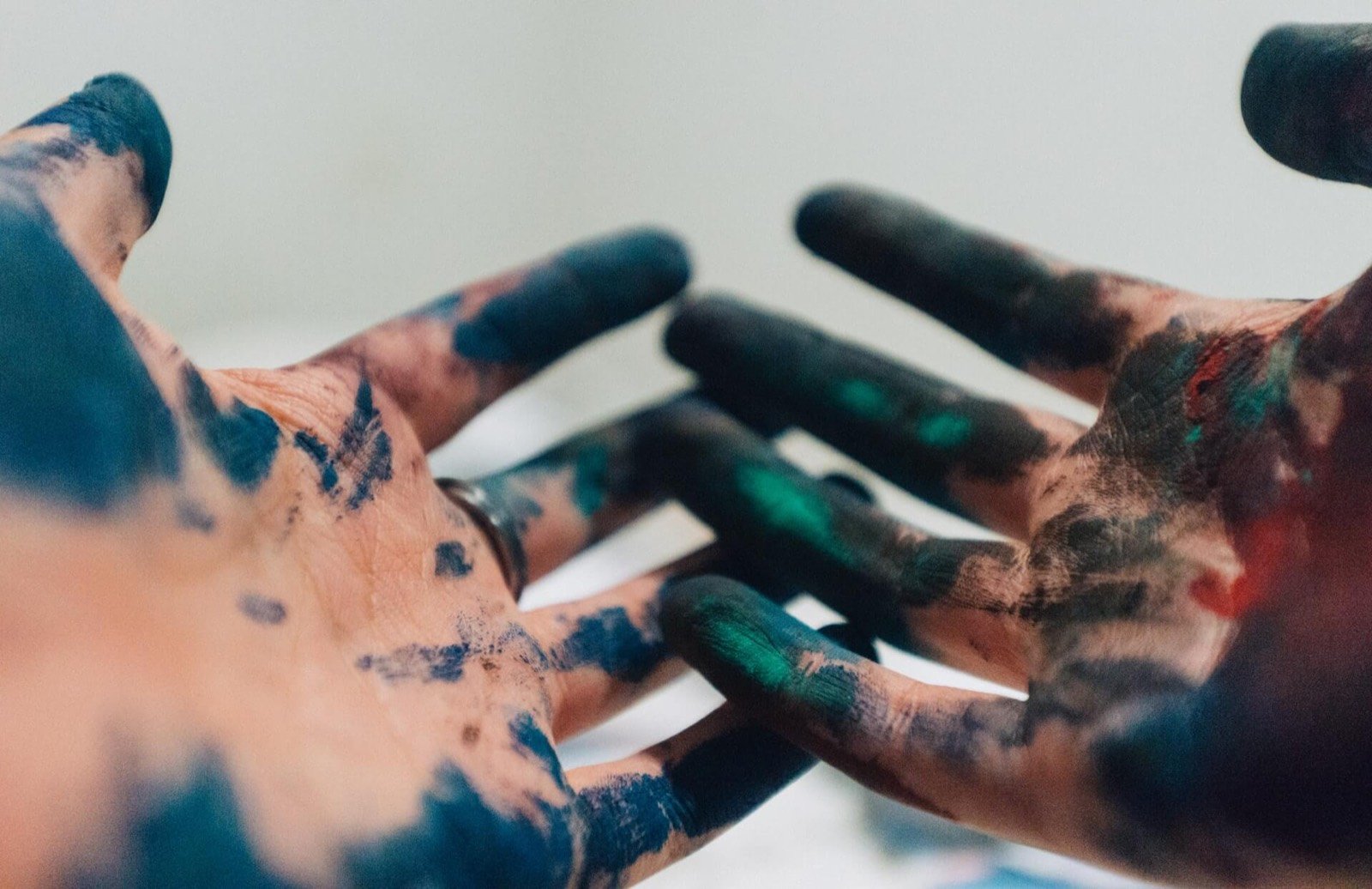 Ilse Varen's hands, covered in blue paint