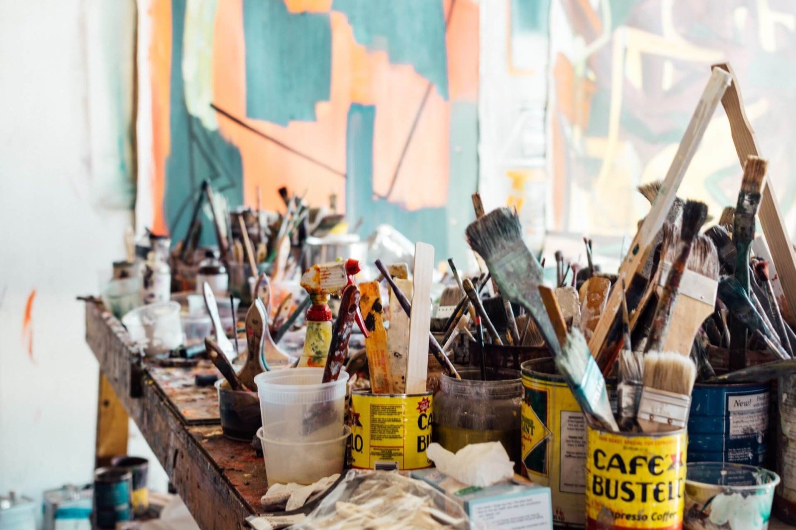 Brushes and paint jars on a studio table