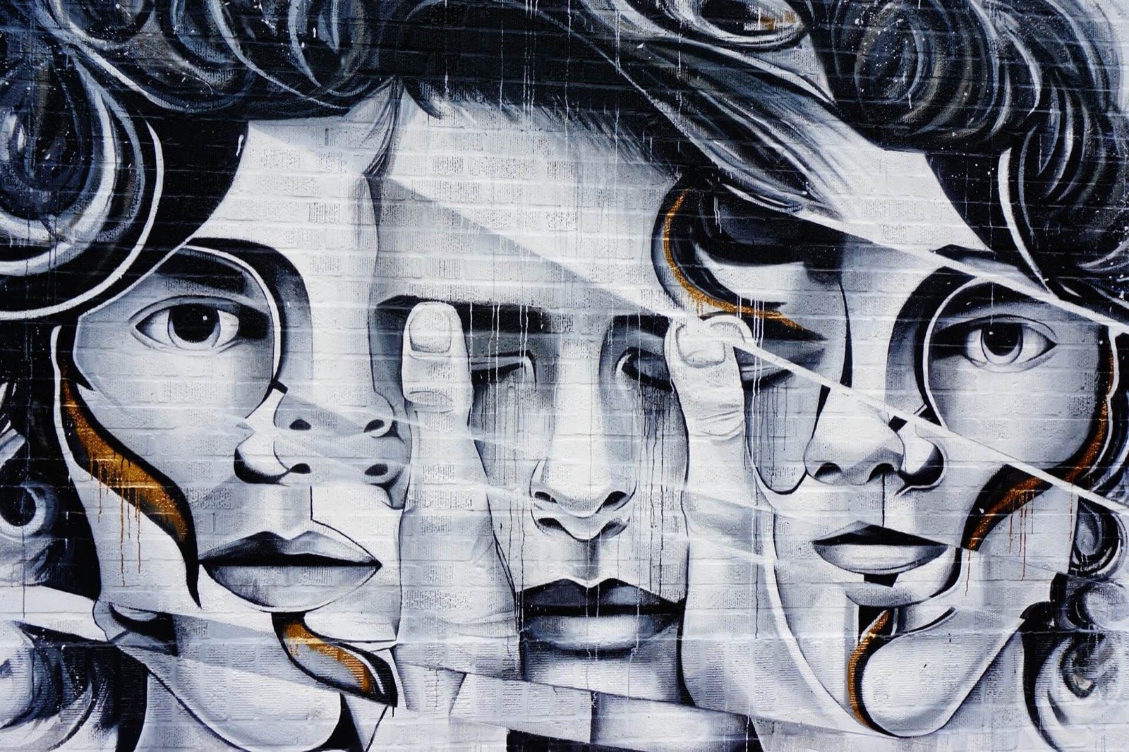 Black and white mural of three faces